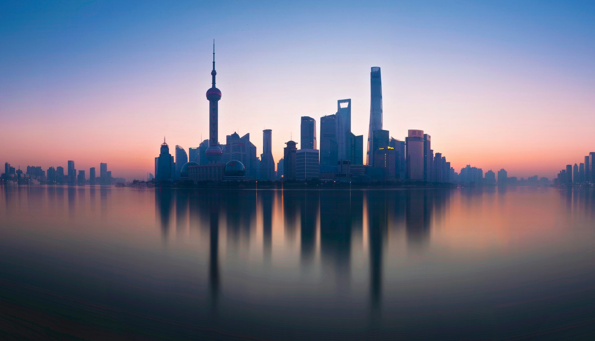 Shanghai skyline reflected in the Huangpu River at dusk